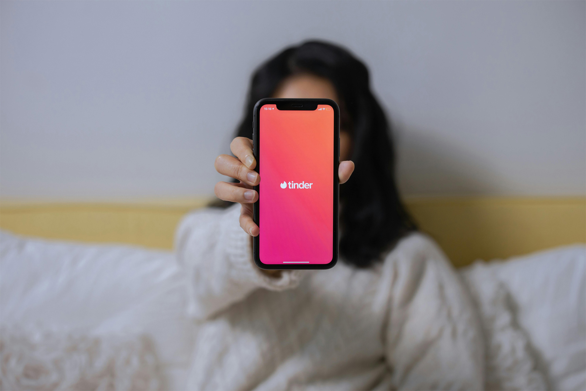 Woman with phone and Tinder app