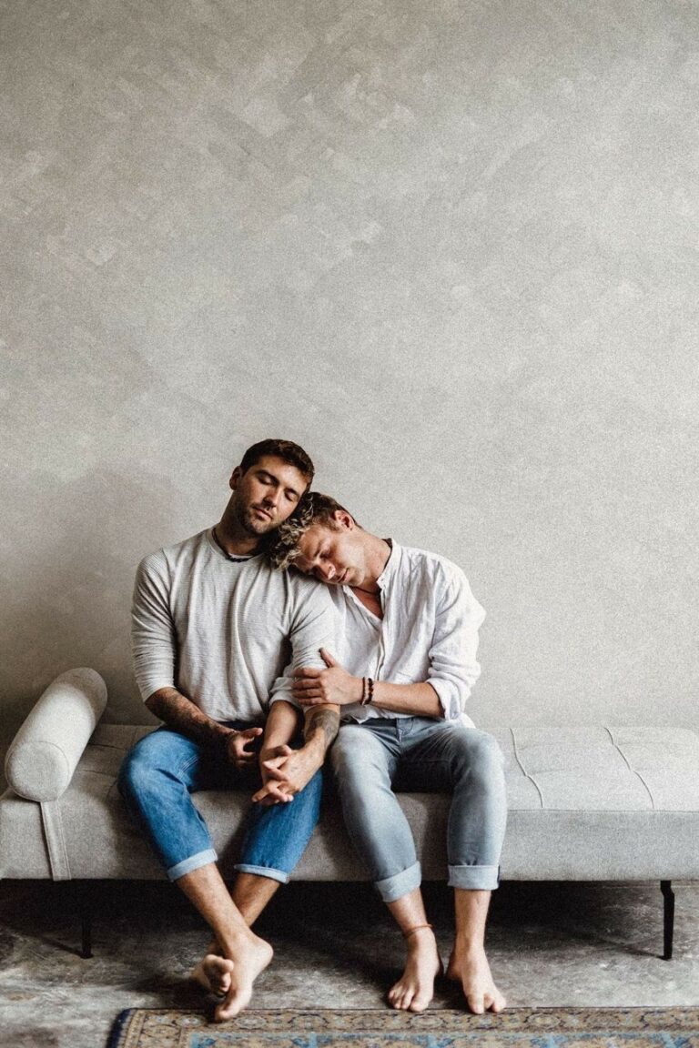 Michael and Tim Overdick are sitting on a couch and cuddling.