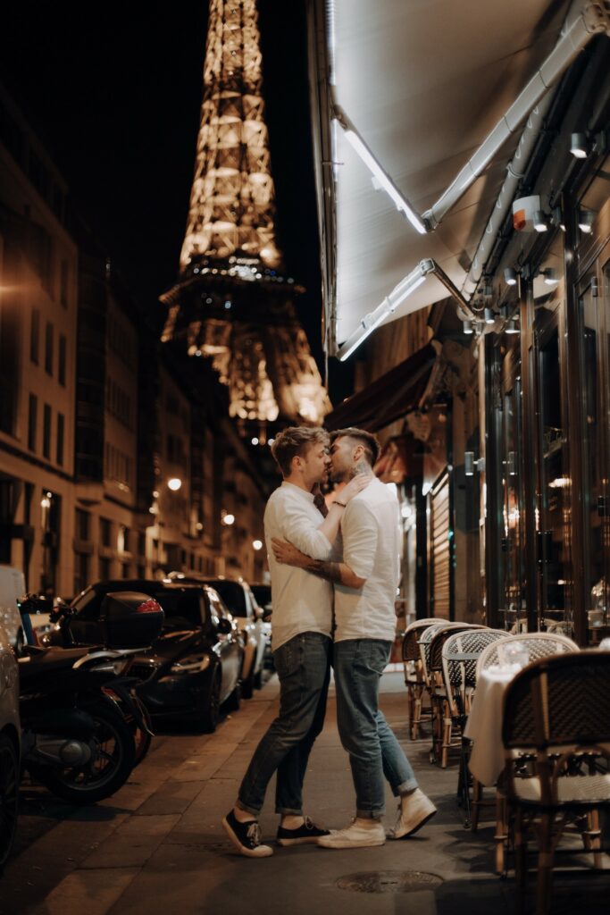 Michael and Tim Overdick are kissing at night.